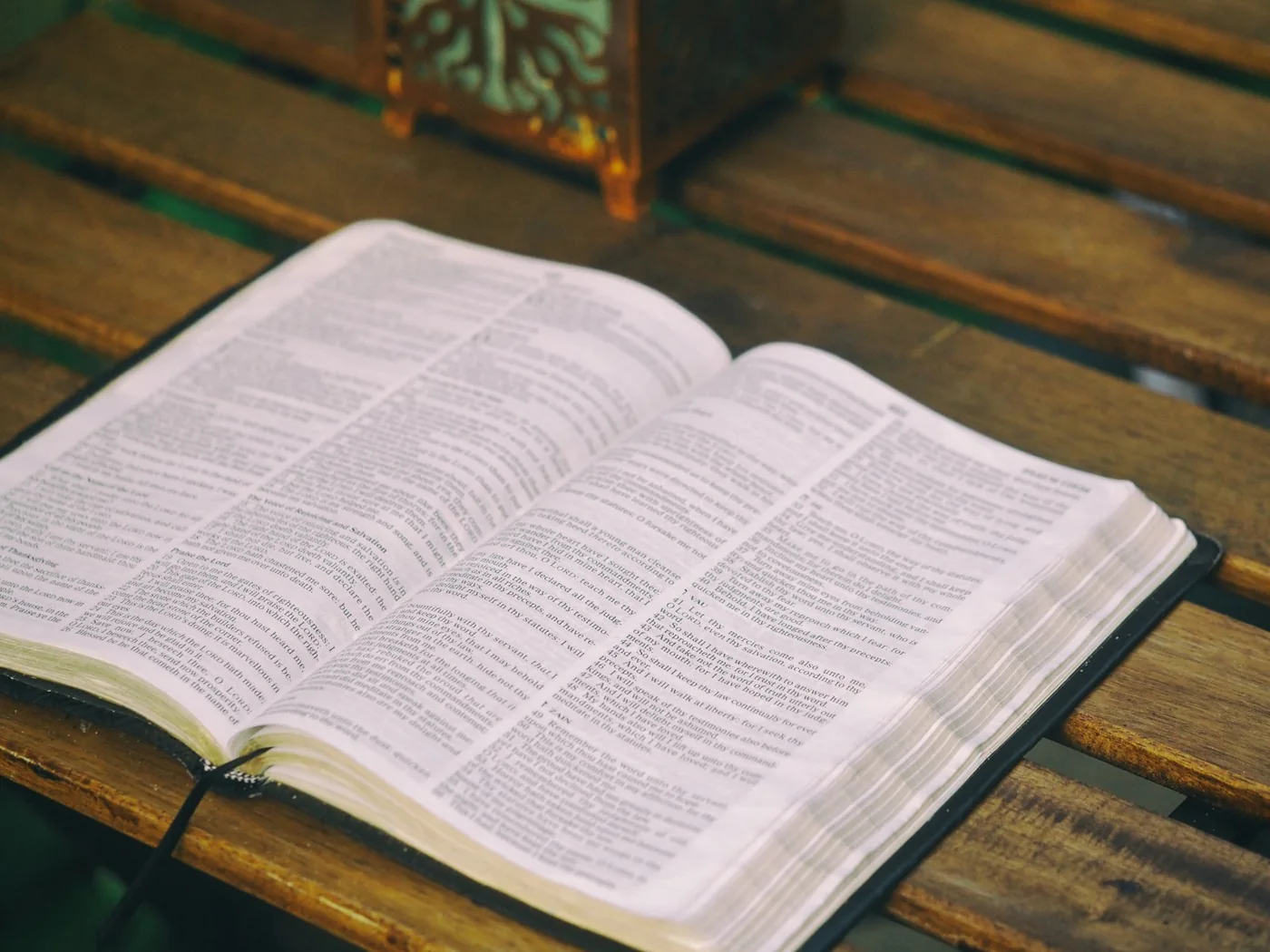 An open Bible on a wooden table